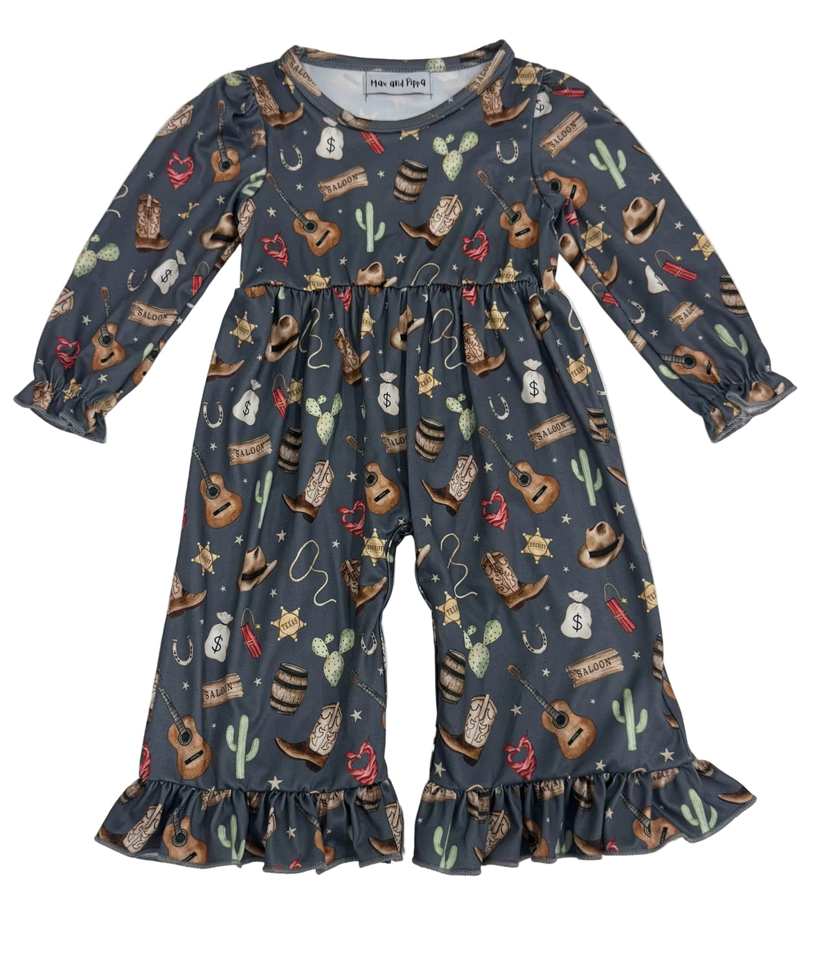A toddler's long-sleeve jumpsuit with a western-themed print, featuring cowboy boots, cacti, stars, and horseshoes on a dark slate gray background. The jumpsuit has ruffled cuffs and a ruffled hem, and is laid flat on a white background.