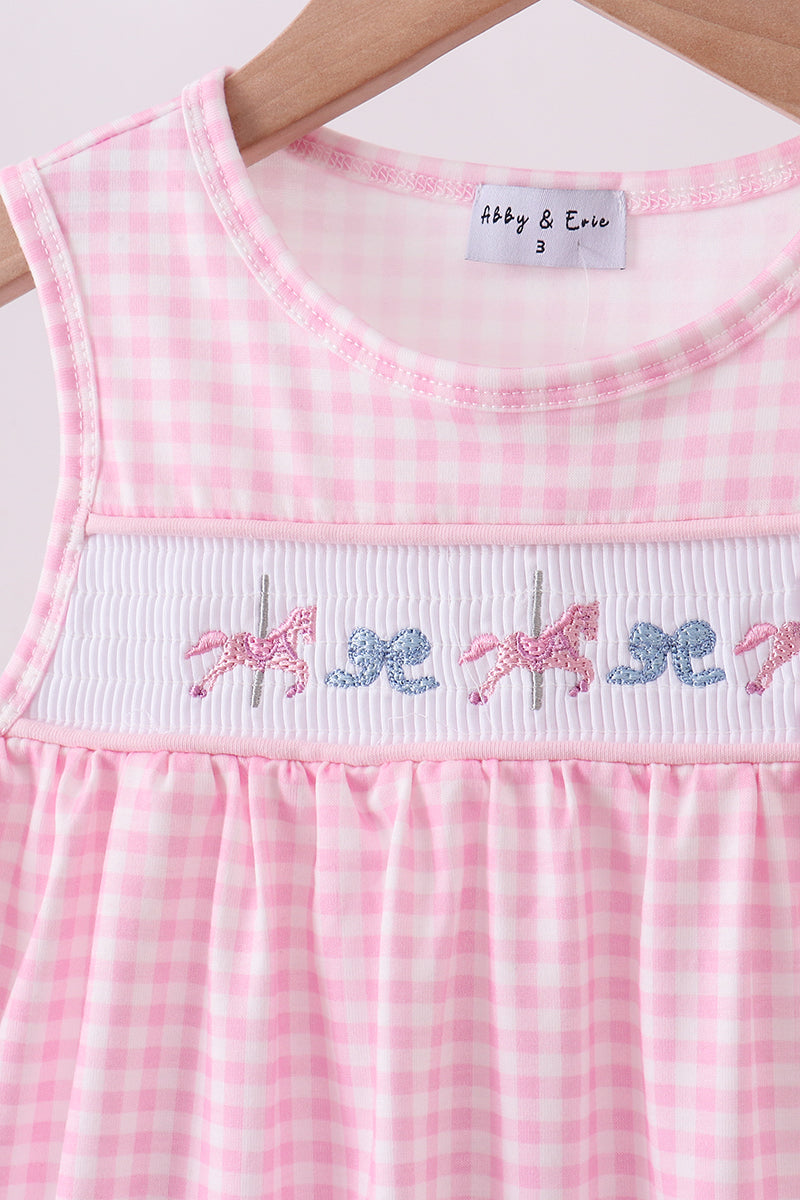 Pink checkered dress with embroidered horses on a hanger