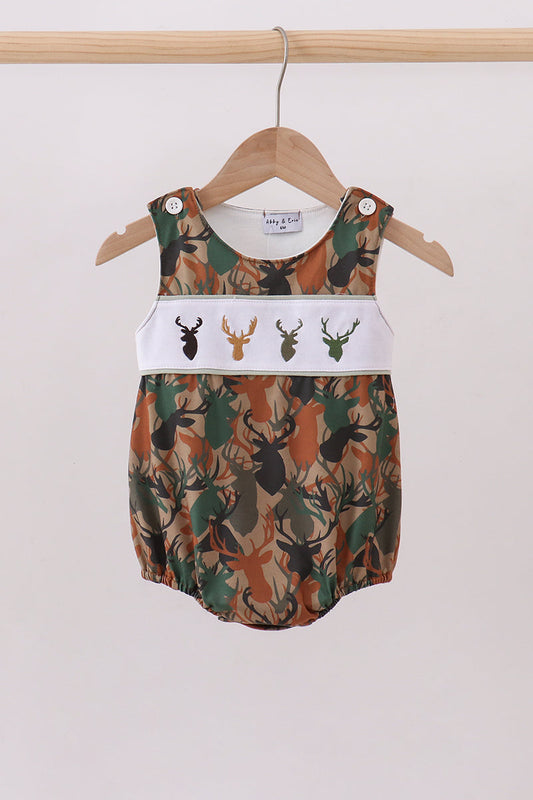 Baby romper with deer pattern on a hanger against a white background